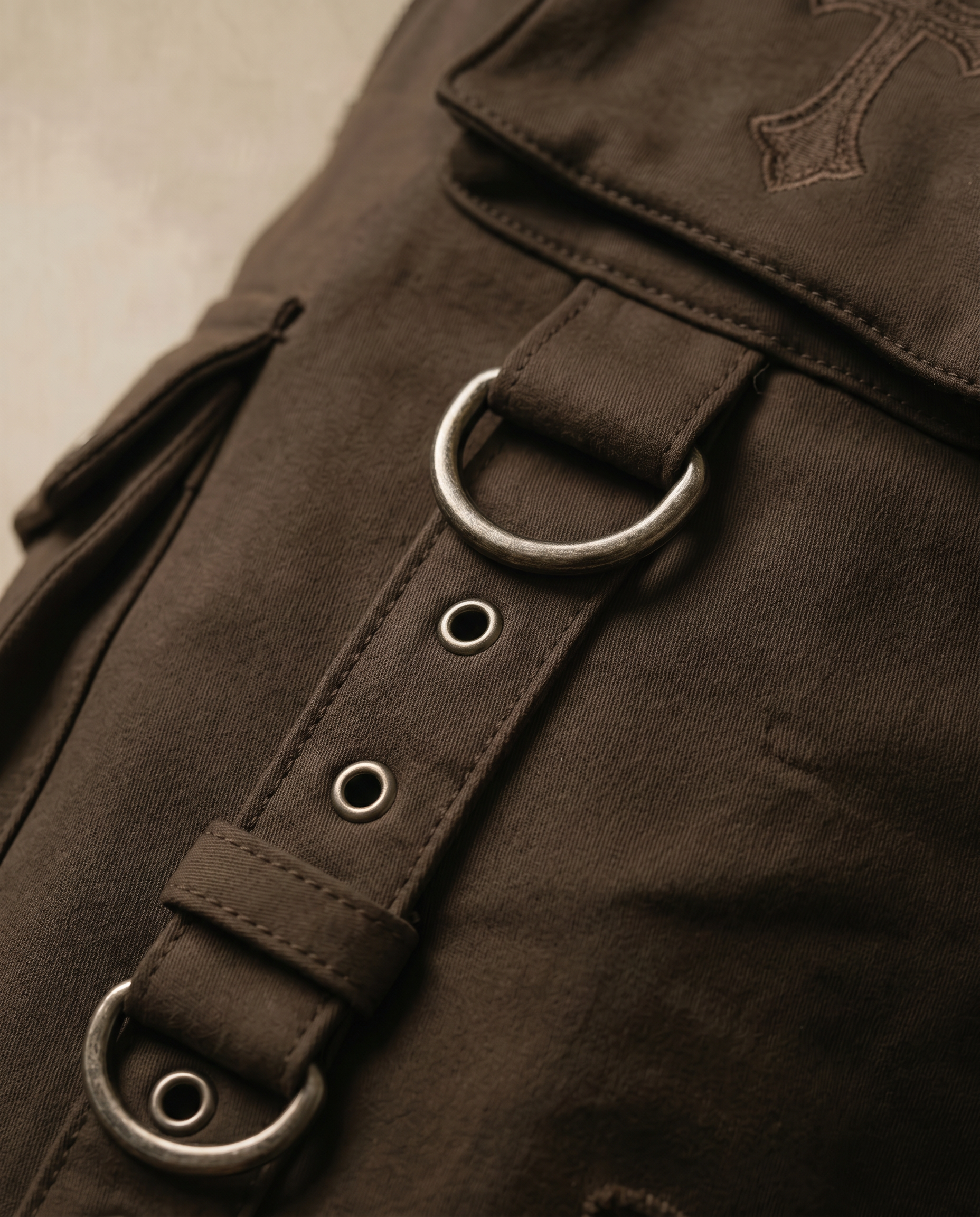 Actively Rich Ascension Noir expresso brown cargo pants detail of utility strap and metal ring hardware highlighting luxury streetwear construction.