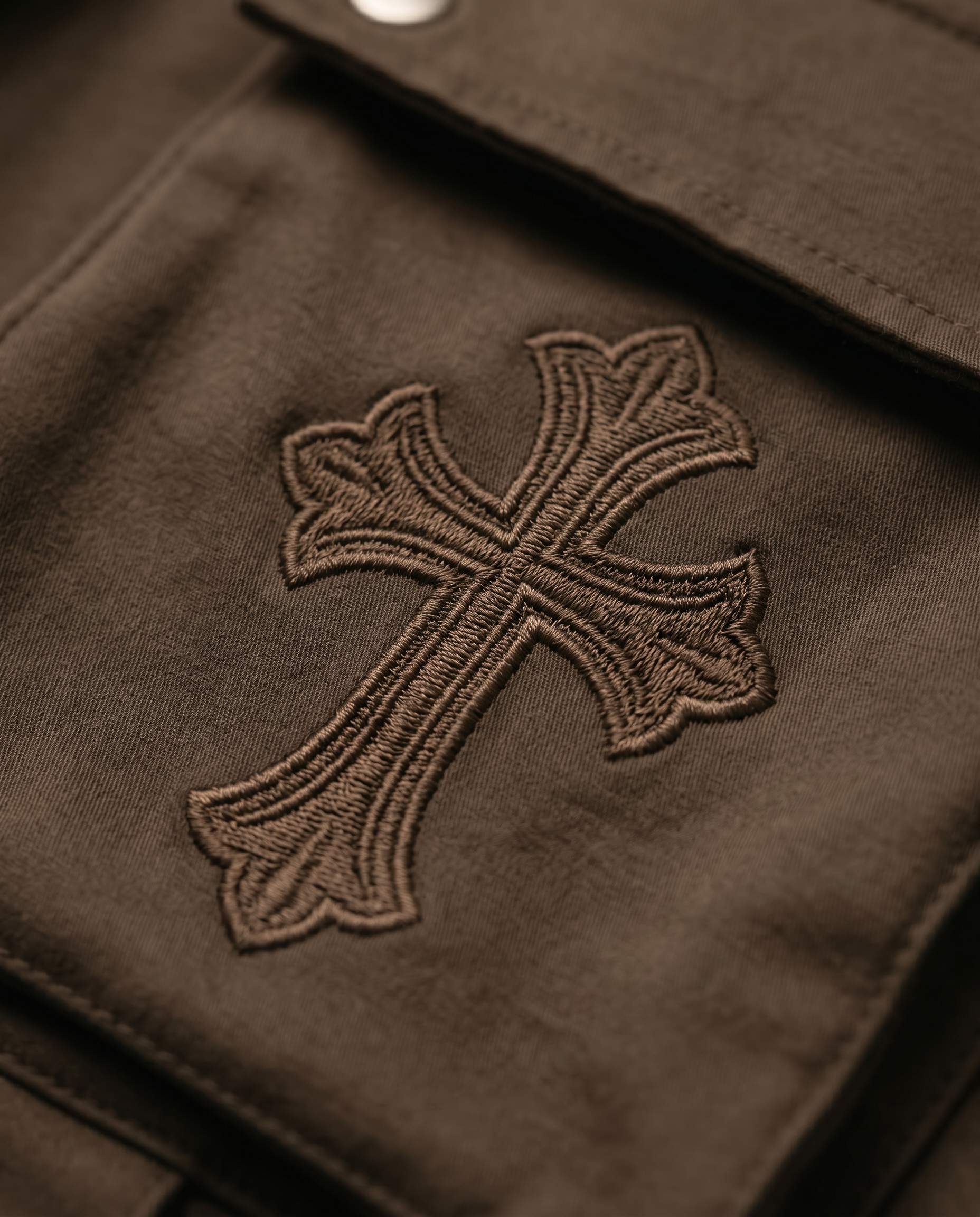 Actively Rich Ascension Noir expresso brown cargo pants cross embroidery highlighting premium stitching and luxury streetwear craftsmanship.